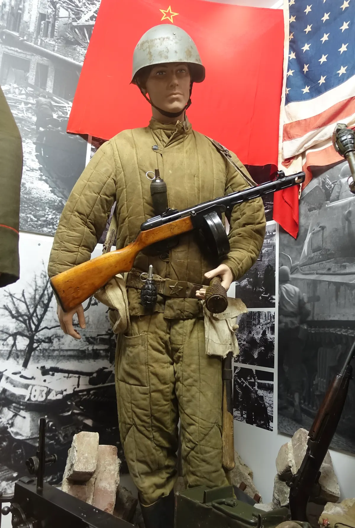 Arquebus Krigshistorisk Museum Norway. WW2 Allied Victory in Europe display. USSR Red Army uniform SSh-40 steel helmet Telogreika Fufaika vatnik padded clothing Buckle PPSh-41 machine gun Hand grenades Soviet US flag photos debris A