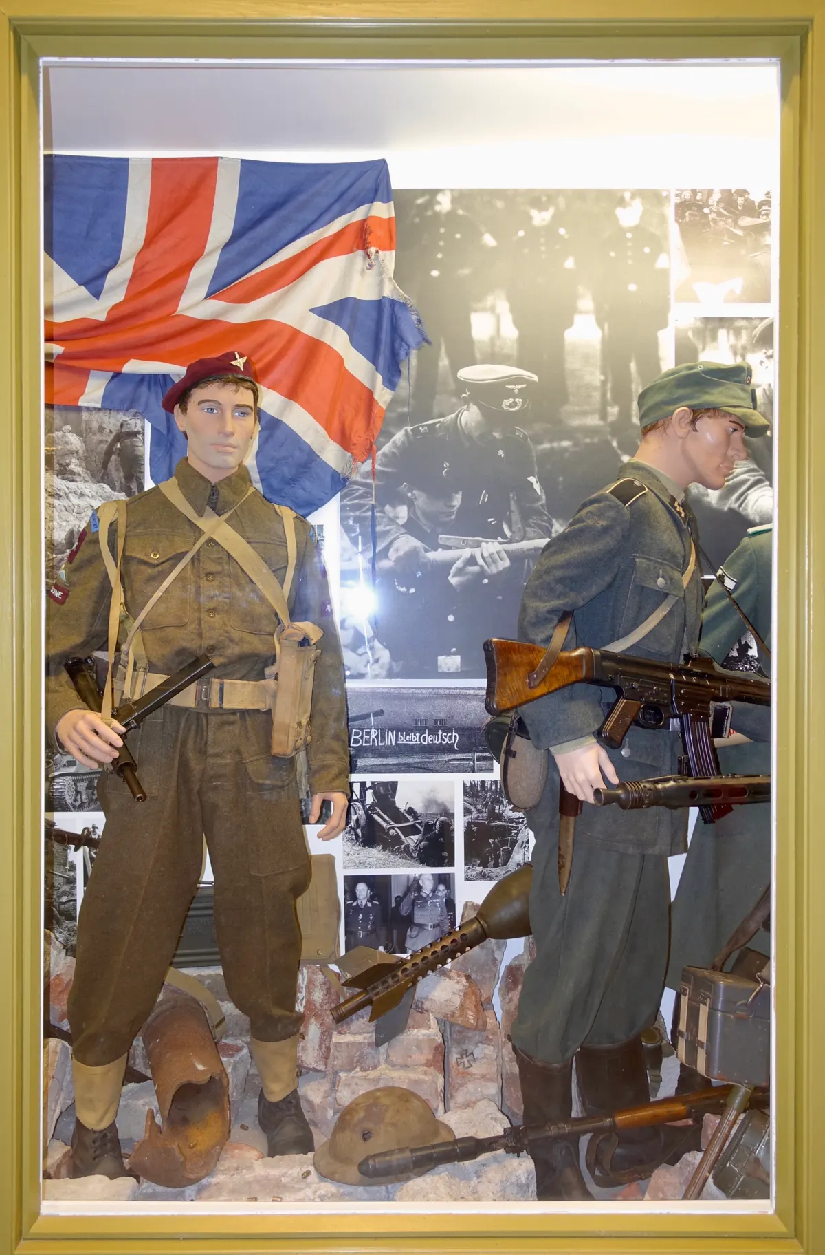 Arquebus Krigshistorisk Museum Norway. WW2 Allied Victory in Europe display. Uniforms weapons equipment ammo British paratrooper battle dress maroon beret Sten Mk V submachine gun UK flag German Waffen-SS StG44 grenades photos etc (2020
