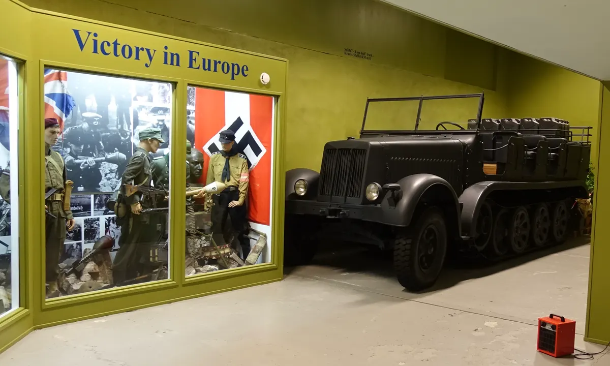 Arquebus Krigshistorisk Museum Norway. WW2 Allied Victory in Europe display. Uniforms weapons British paratrooper battle dress German Waffen-SS Volkssturm Hitlerjugend flags photos etc. 8-ton Half-Track Sd.Kfz. 7 (KM m11) (2020) DSC0839