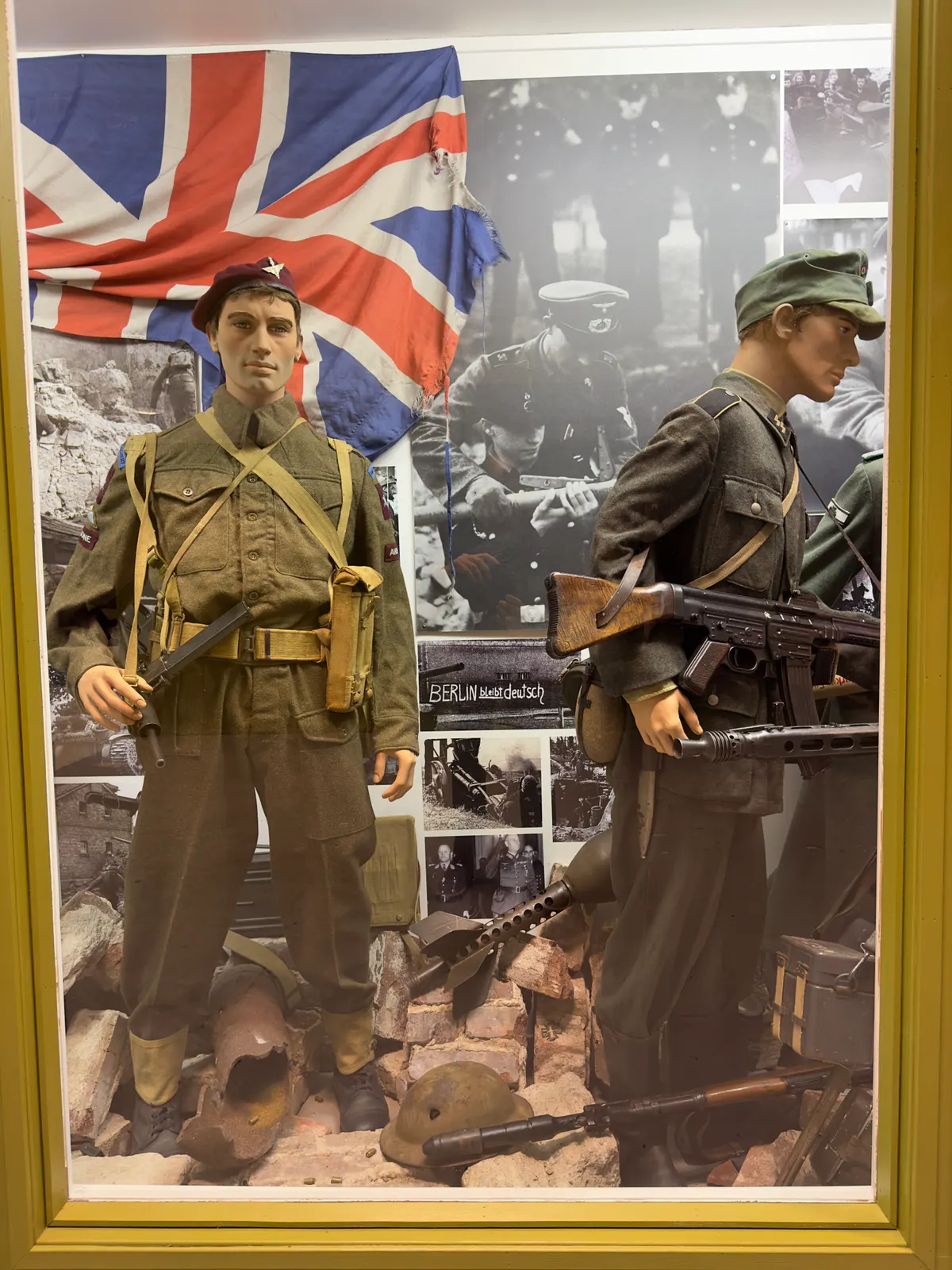 Arquebus Krigshistorisk Museum Norway. WW2 Allied Victory in Europe display. Uniforms weapons equipment ammo British paratrooper battle dress maroon beret Sten Mk V submachine gun UK flag German Waffen-SS StG44 grenades photos etc (202