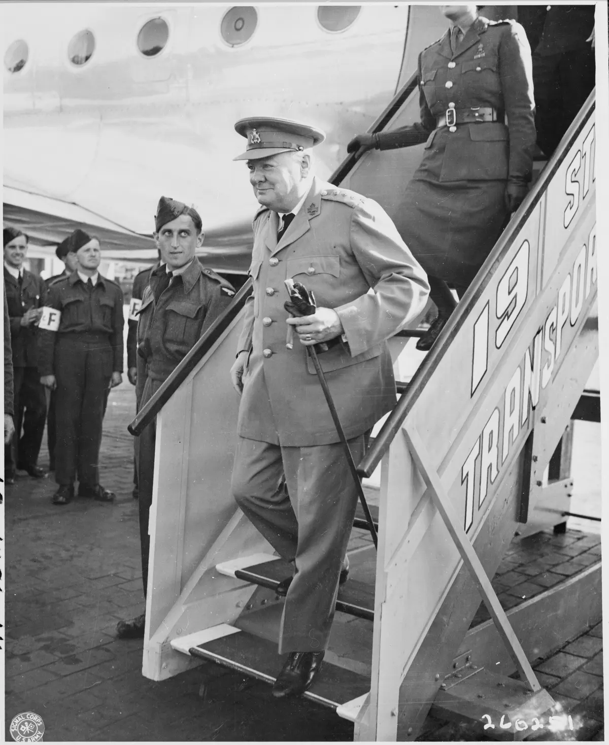 British Prime Minister Winston Churchill steps off his airplane at Gatow Airport in Berlin, Germany en route to the... - NARA - 198863
