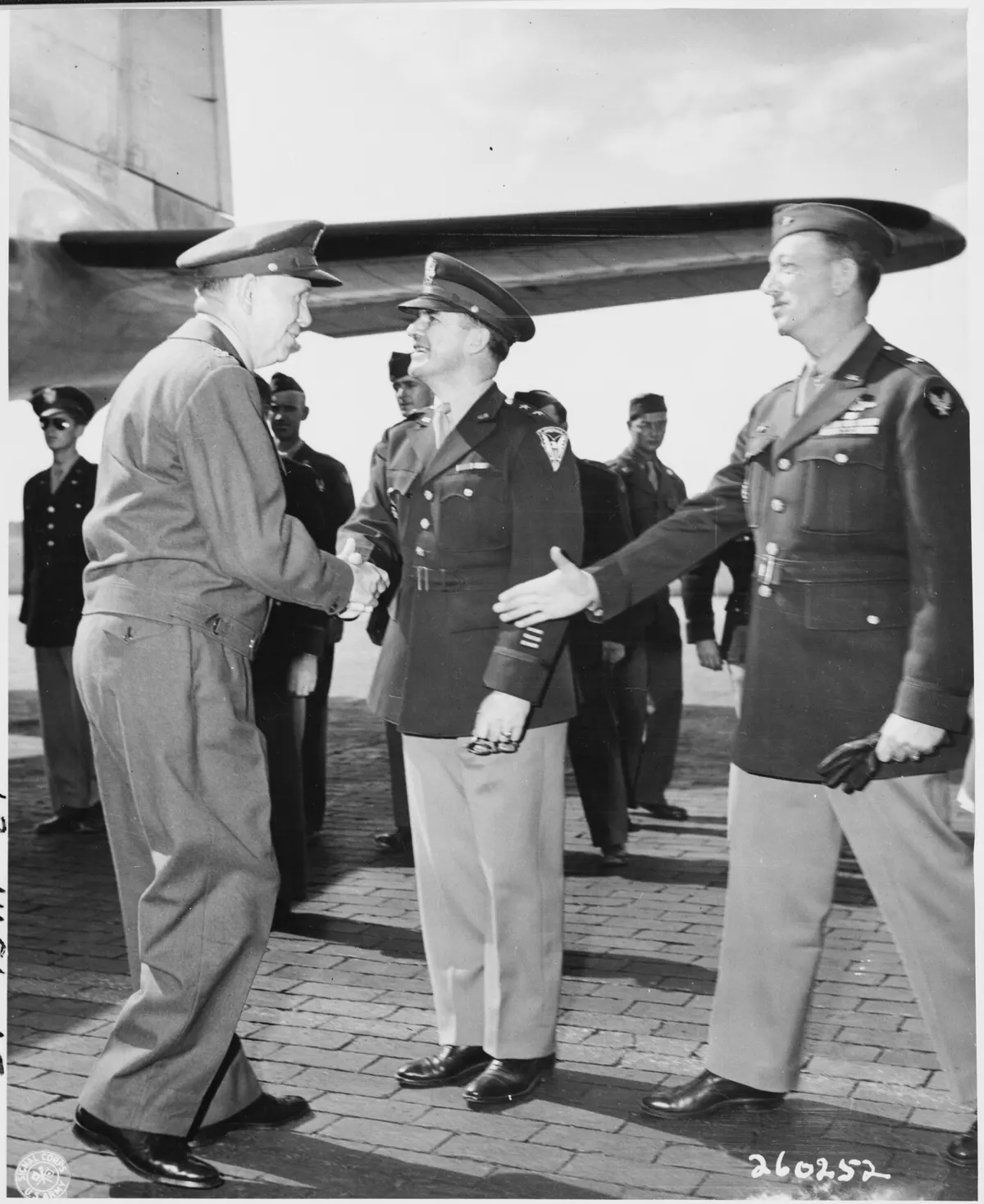 Gen. George C. Marshall shakes hands with Maj. Gen. John R. Deane, center, as Brig. Gen. Ben Stewart Cutler extends... - NARA - 198864