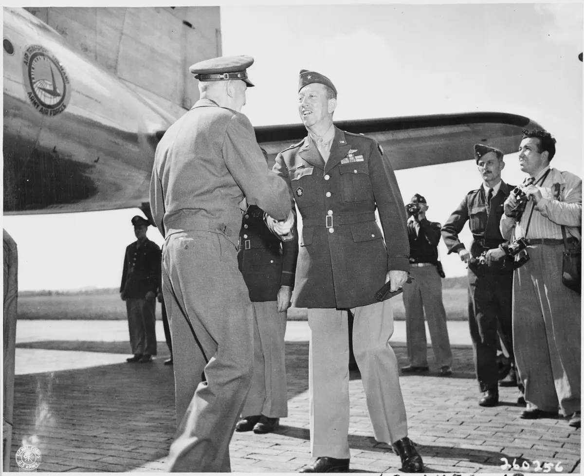 Lt. Gen. Brehon Somervell, left, shakes hands with Brig. Gen. Earl Hoag, right, Commanding General of the Air... - NARA - 198868