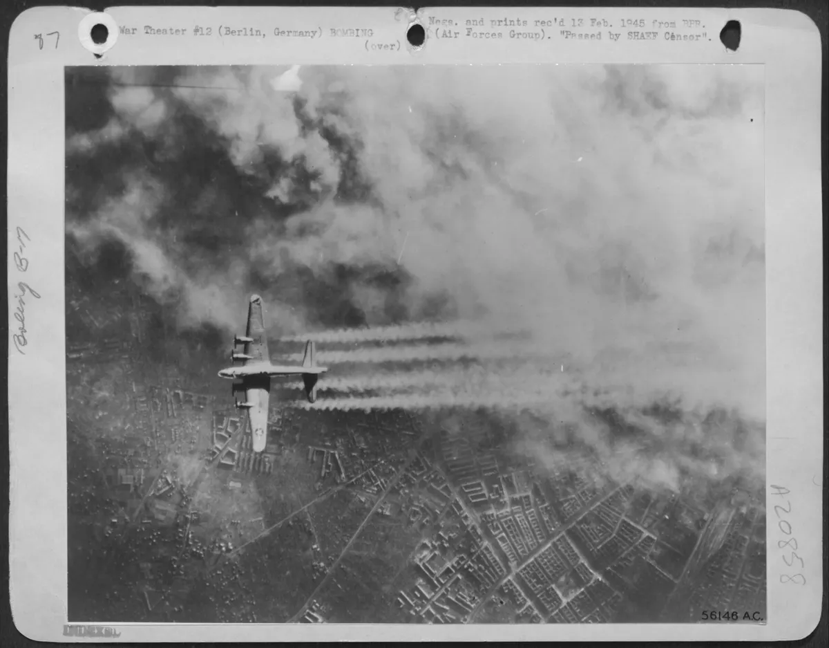 A Boeing B-17 Flying Fortress of the U.S. Eighth Air Force passes over the heart of Berlin as smoke from fires started in the Tempelhof area blanket part of the capital, Feb. 3, 1945. This was one of a force of 1,000 planes which unloaded 2