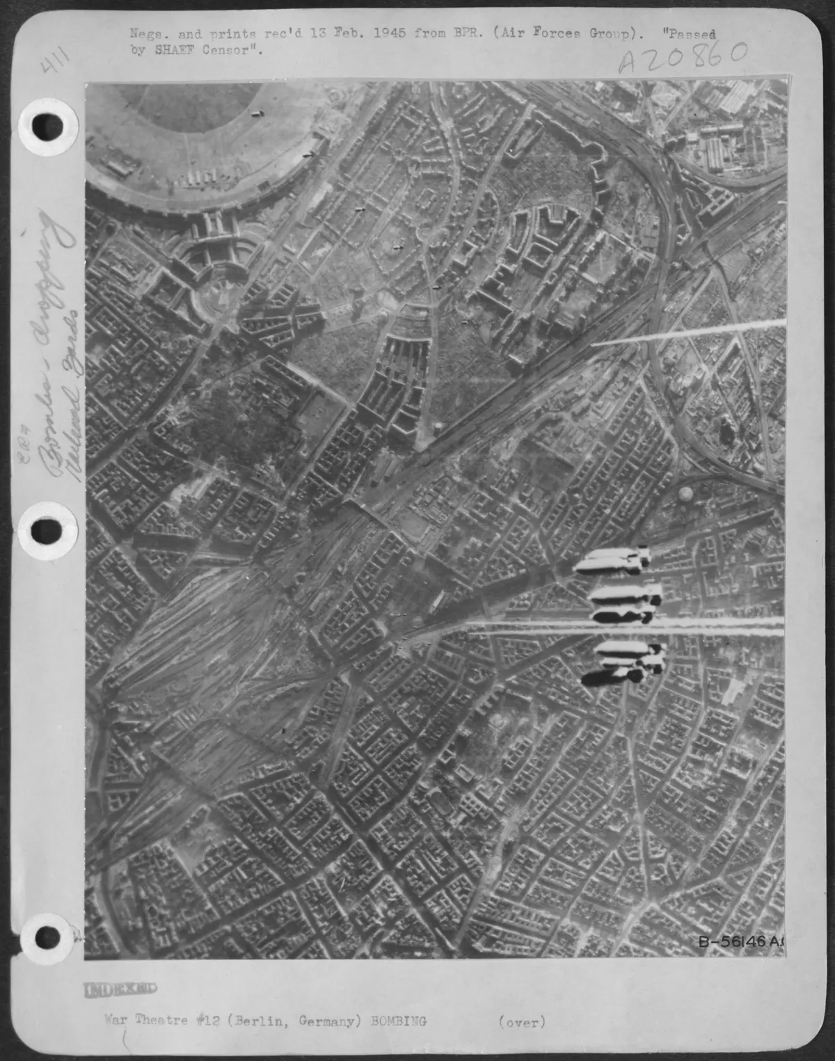 Initial bombs from Boeing B-17 Flying Fortresses of the U.S. 8th Air Force head for the heart of Berlin, Germany during the Feb. 3, 1945 daylight assault on Hitler's capital. Upper right is Tempelhof airdrome and the Tempelhof rail yards. (