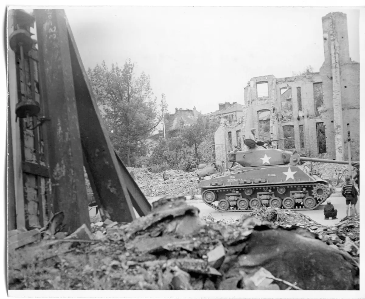 German Children Watch as a U.S. 2nd Armored Division Tanks Drives Through Rubble-Strewn Street in Berlin, Germany